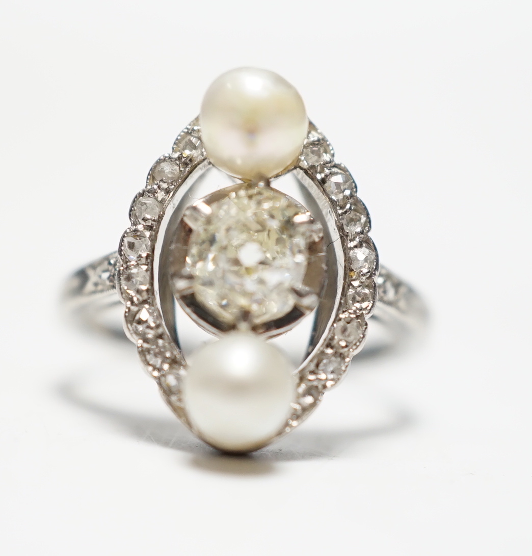 A white metal single stone diamond and two stone cultured pearl set oval ring, with diamond chip set borders and shoulders, size F, gross weight 4.4 grams.